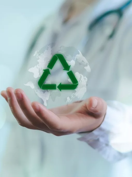 Person in white lab coat holding glowing holographic recycle sign, signifying medical personnel or high tech healthcare concept.